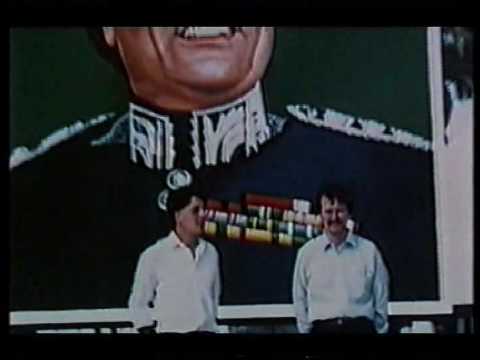 fascist loons Nick Griffin and Derek Holland pose under a Gaddafi portrait in Libya